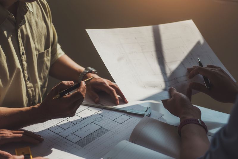 contractors reviewing architectural plans