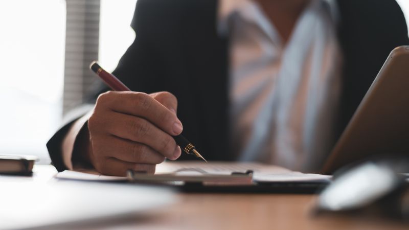 Businessman in suit signing a contract