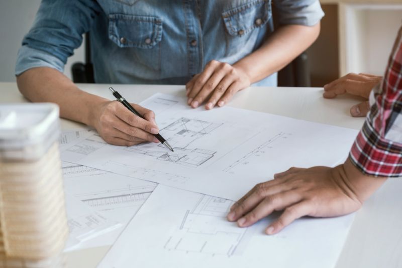 Two contractors reviewing construction plans