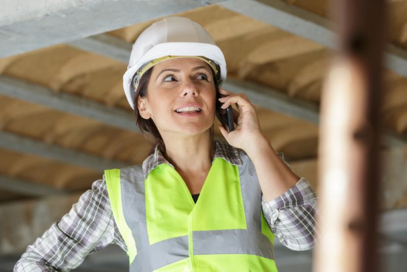 Construction worker on a phone call while working